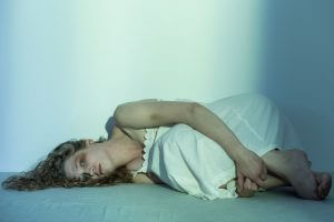 Young molested woman lying on the floor